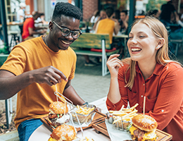 two young adults enjoying burgers