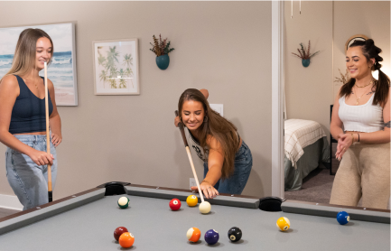 A group of women playing pool.